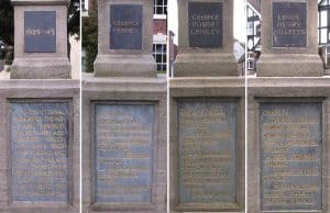 Four stone plaques on a memorial, each engraved with names and inscriptions, honouring individuals or events.